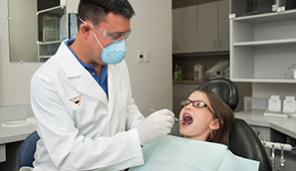 Dentist working on child